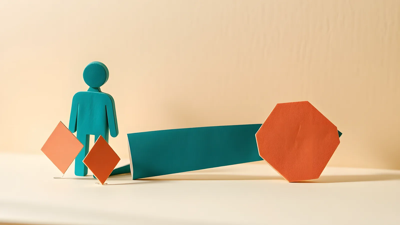 A small coral paper diamond on the left, a bold teal paper arrow across the centre, and a larger coral paper hexagon on the right, all on a warm cream paper background
